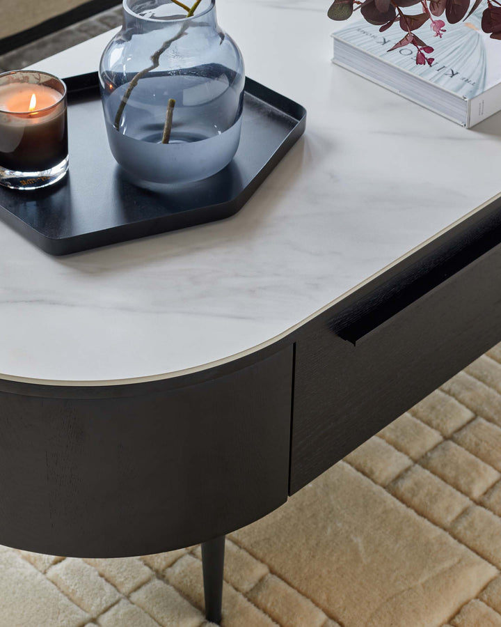 Stylish coffee table with a marble effect top, black wood trim and a drawer for storage.