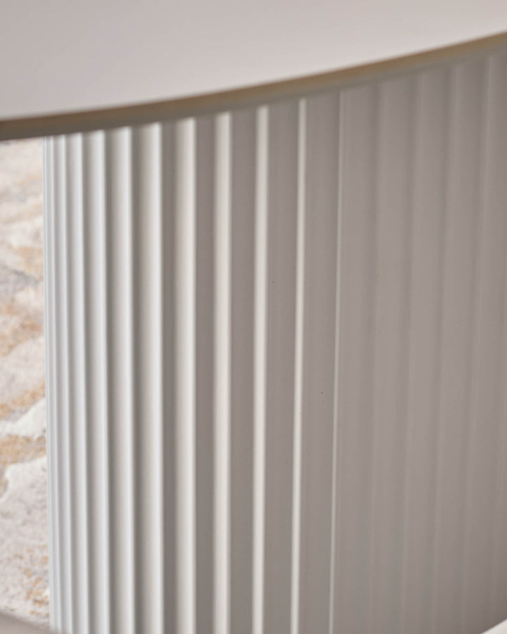 Austin ceramic fluted dining table in white, close-up of textured vertical ribbed surface detail.