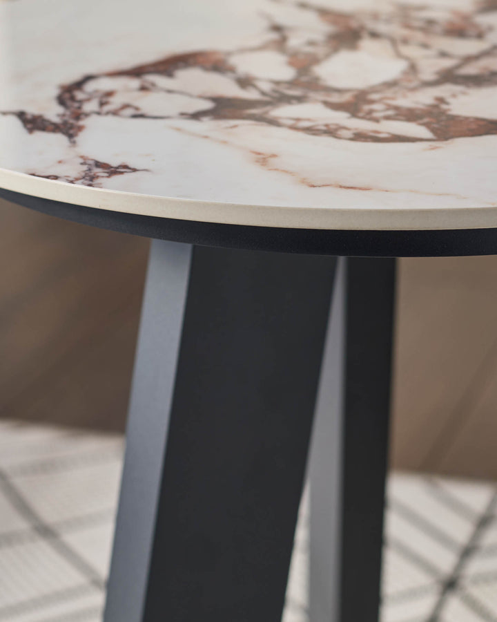 Bianco garden side table with white Calacatta marble top and black pedestal base, angled view.
