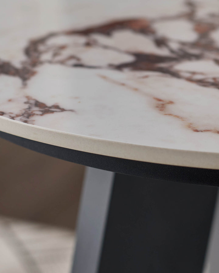 Bianco Garden side table with white Calacatta marble top and black base, angled view showing curved edge detail.