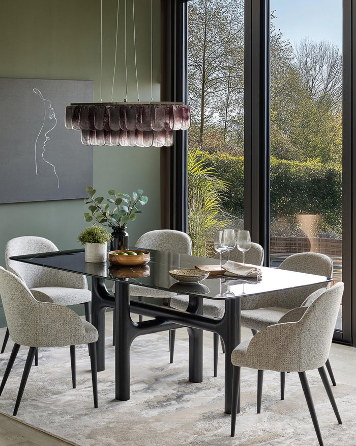 A modern dining set featuring a black glass table, six upholstered chairs, and a unique chandelier.