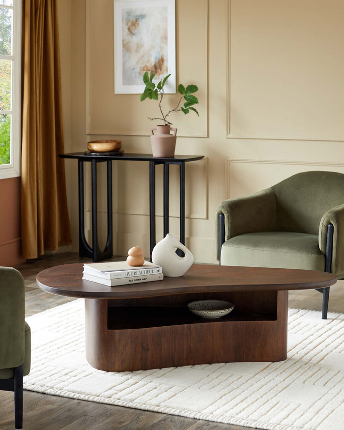 A stylish living room featuring a wooden coffee table, console table and two modern velvet armchairs.