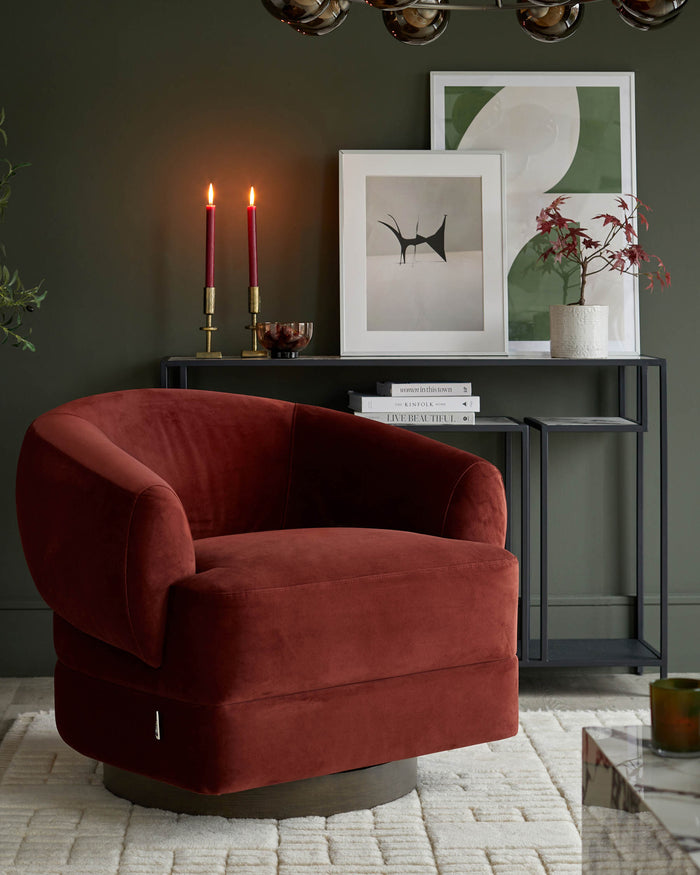Stylish living room featuring a plush, red velvet swivel chair, alongside a console table with artwork and decorative items.