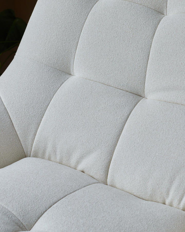 Close-up of a white, tufted, soft-textured sofa cushion. Modern design that looks comfy and stylish.