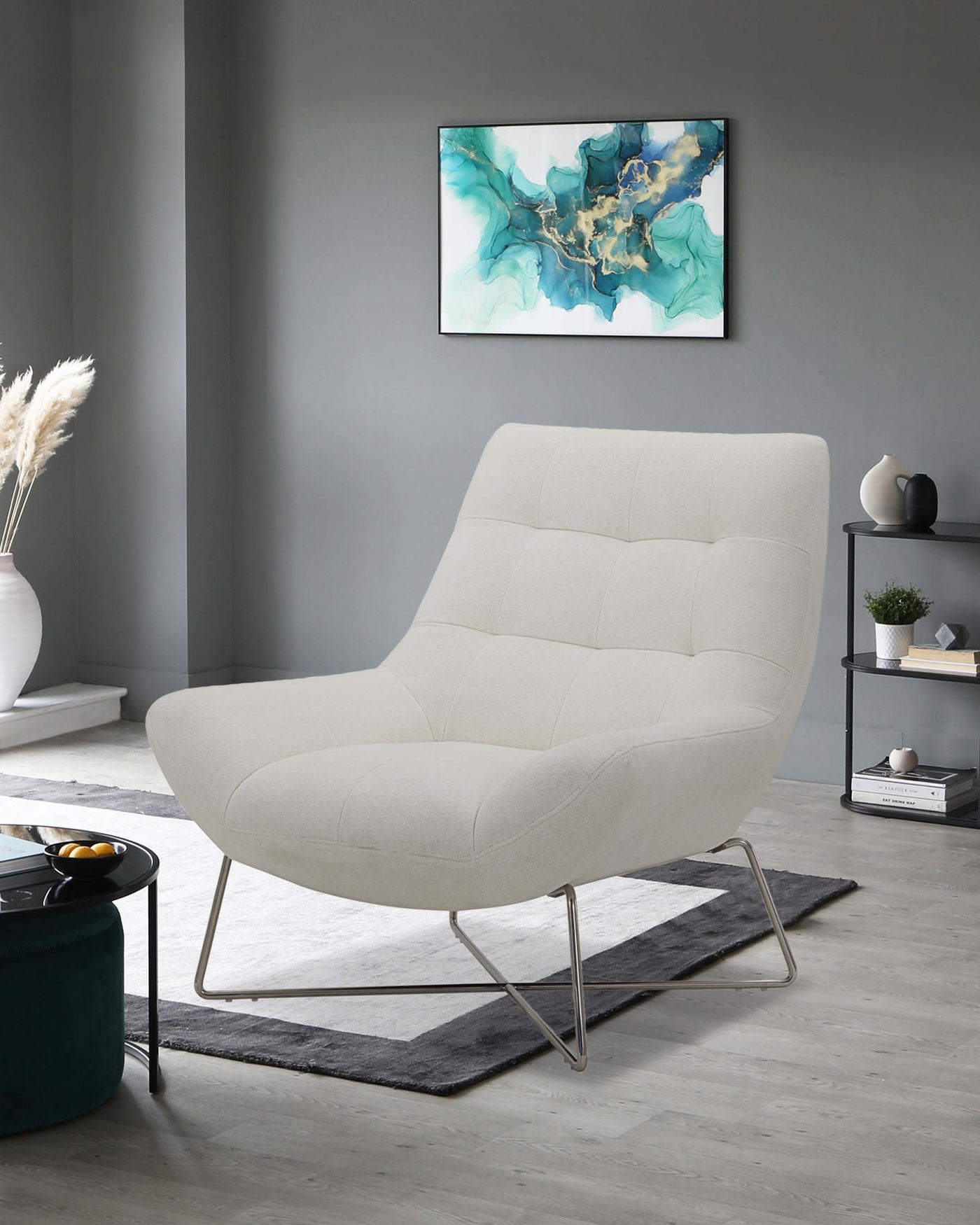 Modern beige upholstered lounge chair with unique curved silhouette and quilted detailing, supported by thin chrome legs, displayed on a grey and black area rug in a contemporary styled room.