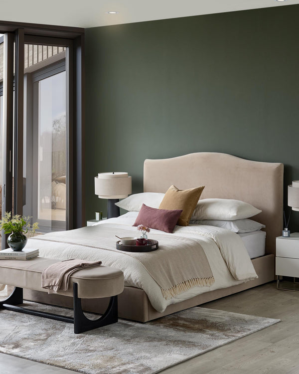 Bedroom with beige bed, bench and lamps. Stylish, modern interior design.