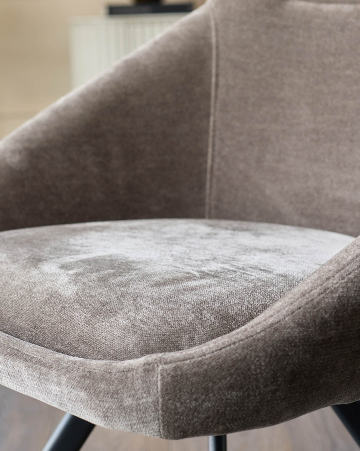 Close-up of a stylish, upholstered chair in a neutral tone, offering comfort and contemporary design.