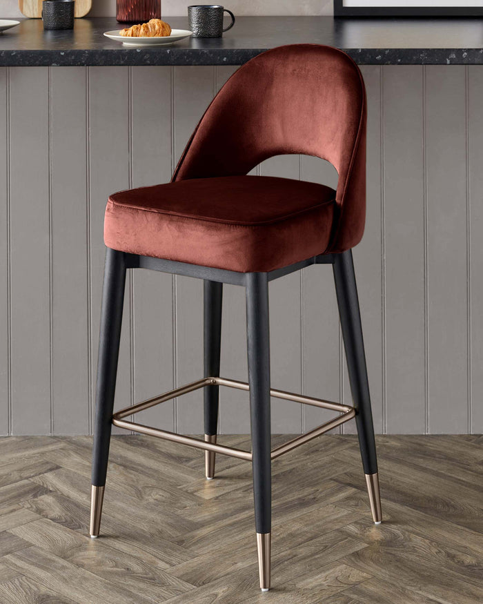 A stylish velvet bar stool with black legs and a supportive back, perfect for any kitchen or bar area.