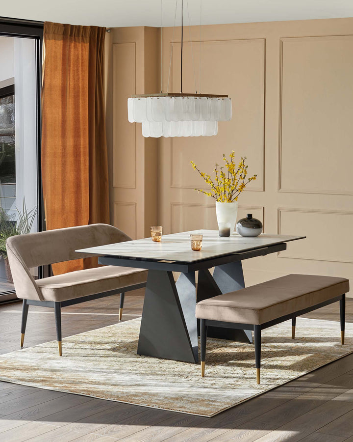 A dining table with marble top and bench seating underneath a modern chandelier, creating an elegant dining space.
