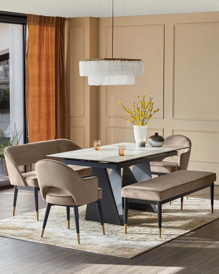A modern dining set featuring a white marble table, beige velvet chairs, and a unique chandelier.