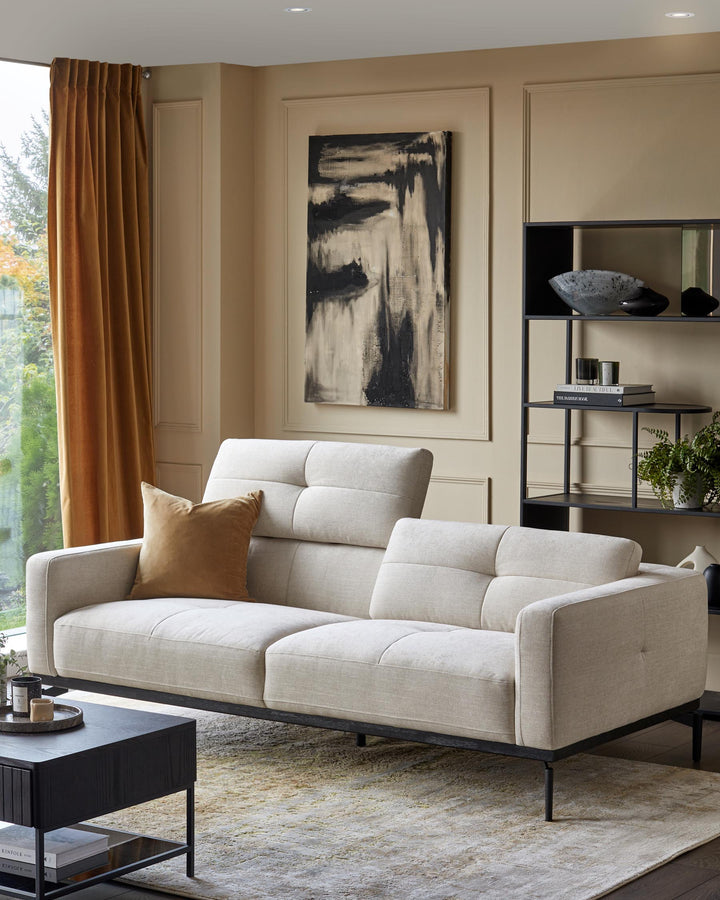 A modern living room with a comfy sofa, dark wood coffee table, and shelving unit, creating a stylish and inviting space.