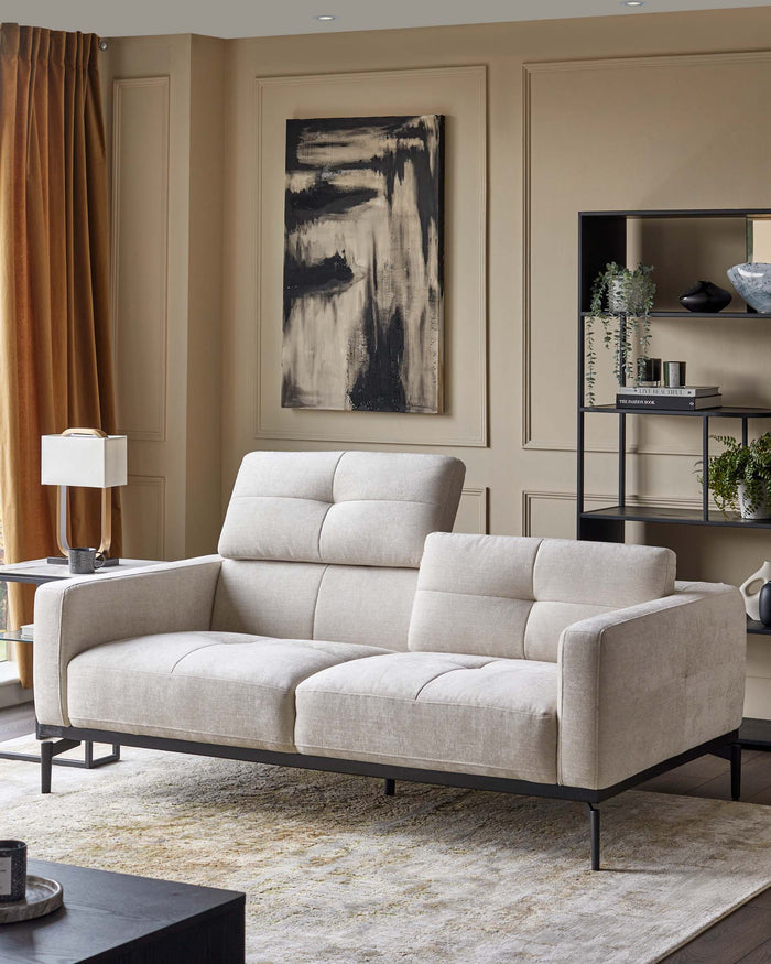 A modern two-seater sofa with a light fabric finish and black metal frame is the focal point in this stylish living room setting.