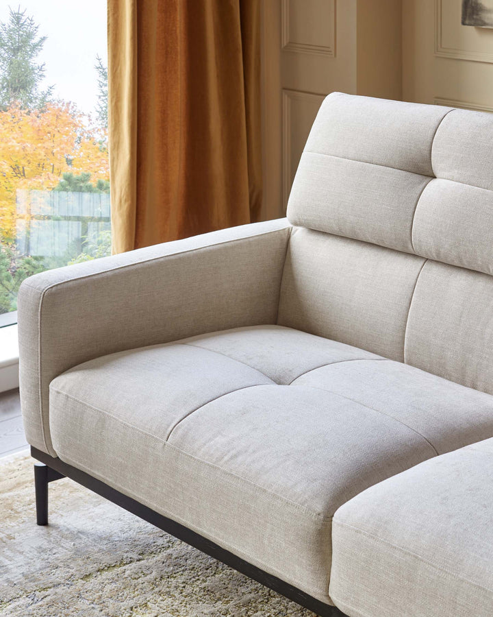 A stylish, light beige sofa with a modern design. Perfect for a contemporary living space.