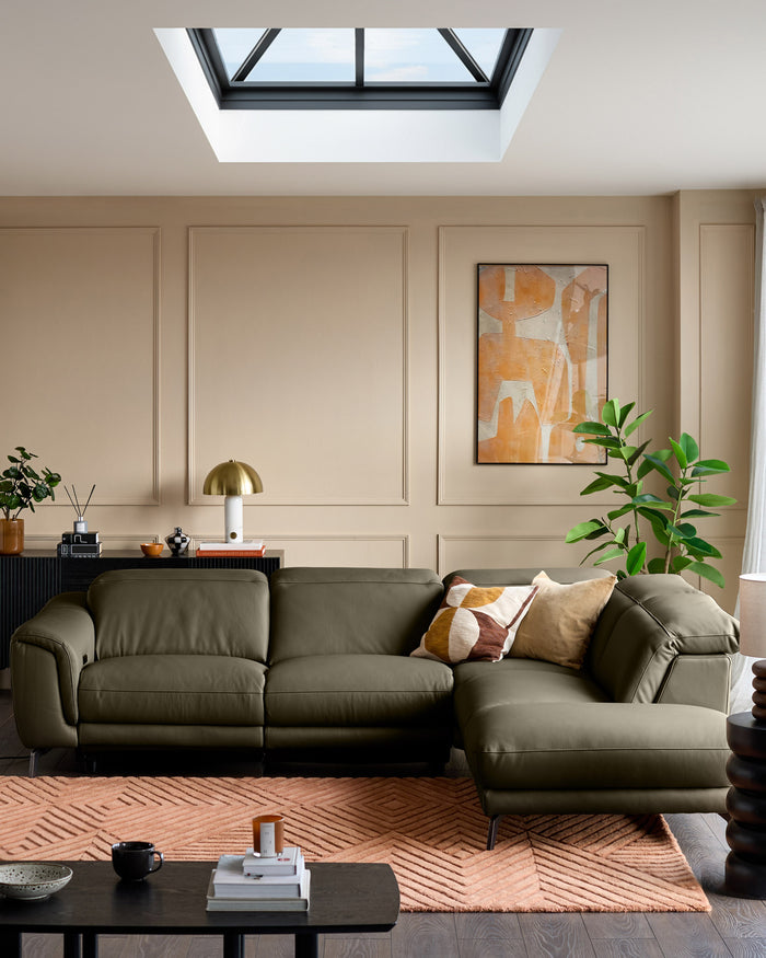 Connor right-hand corner chaise sofa in olive green leather, displayed in a modern living room setting.