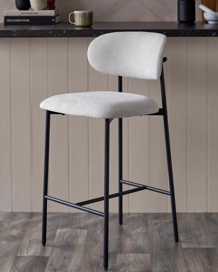 A modern bar stool with a light grey seat and backrest, supported by a sleek black metal frame.