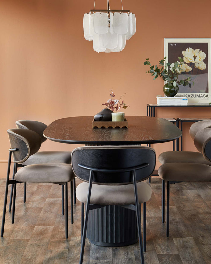 A dining set with a wooden table, 4 chairs and a feature light. A stylish room with warm tones.