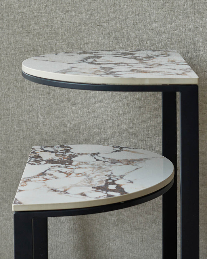 Two-tiered marble effect side table with dark metal frame. Modern design.