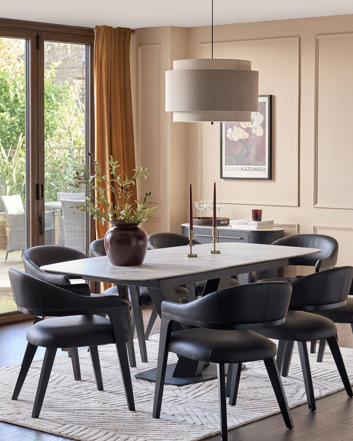 Leonie pendant light in natural linen with mocha accents, displayed above a dining table in a modern room setting.