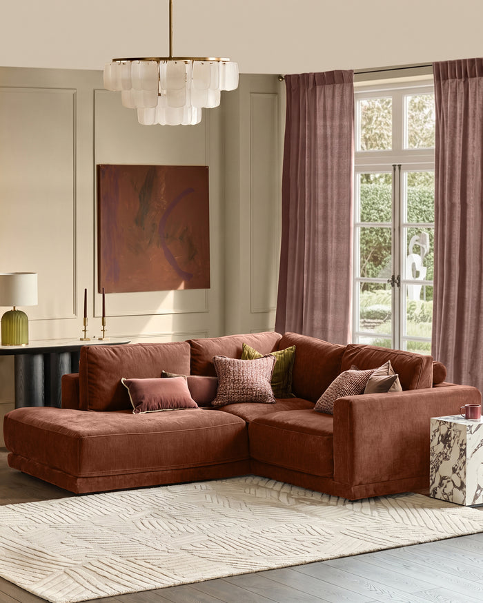 Eden left small chaise sofa in apricot fabric, styled in a modern living room with decorative pillows and neutral décor.