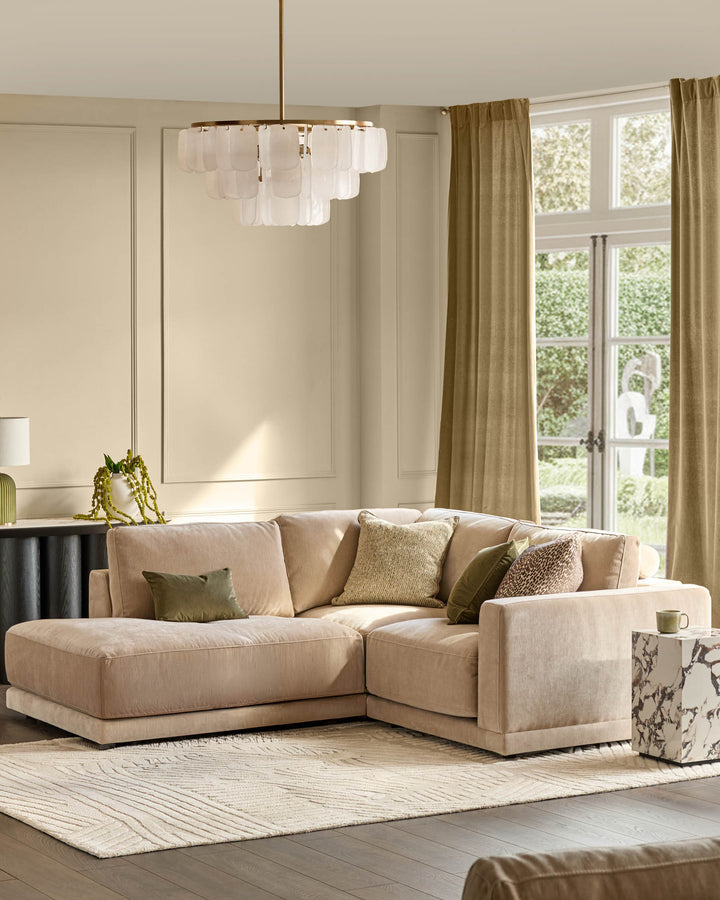Eden left small chaise sofa in champagne fabric, styled in a modern living room with decorative pillows and neutral decor.