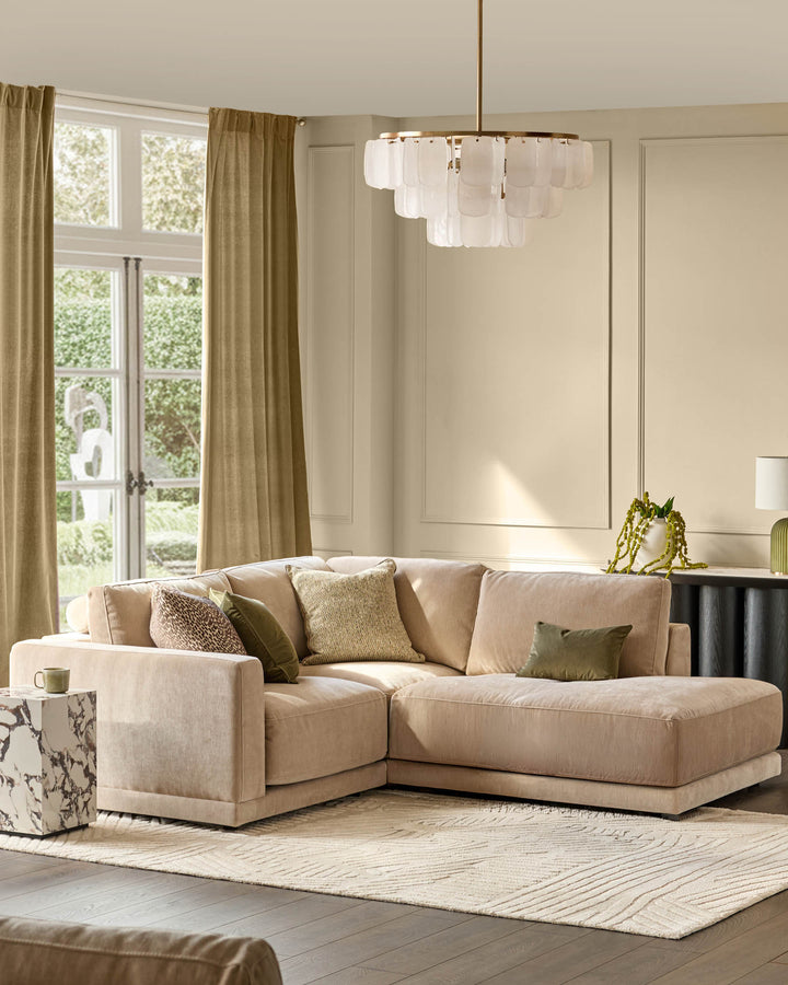 Champagne fabric right-facing sectional sofa with small chaise lounge, shown in a bright living room setting.