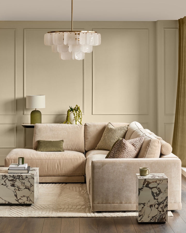 Eden left large chaise sofa in champagne fabric, shown in a styled living room setting with cushions and pendant lighting.