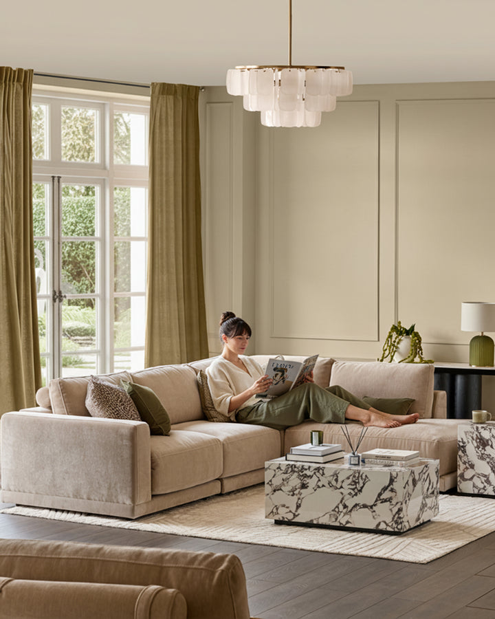 Eden right large chaise sofa in champagne fabric, displayed in a neutral living room setting with decorative pillows.
