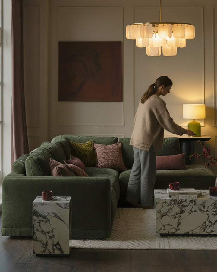Dark green fabric right-facing large chaise sofa with cushioned armrests, styled in a modern living room setting.