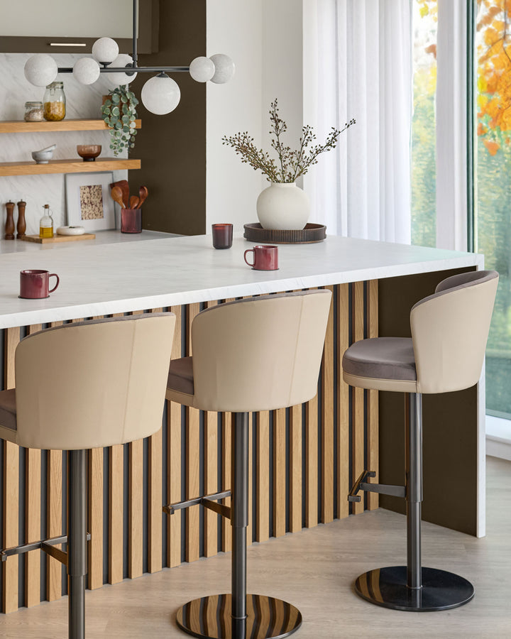 Elodie gas lift bar stool in mocha velvet with natural wood striped base and footrest, shown in modern kitchen setting.
