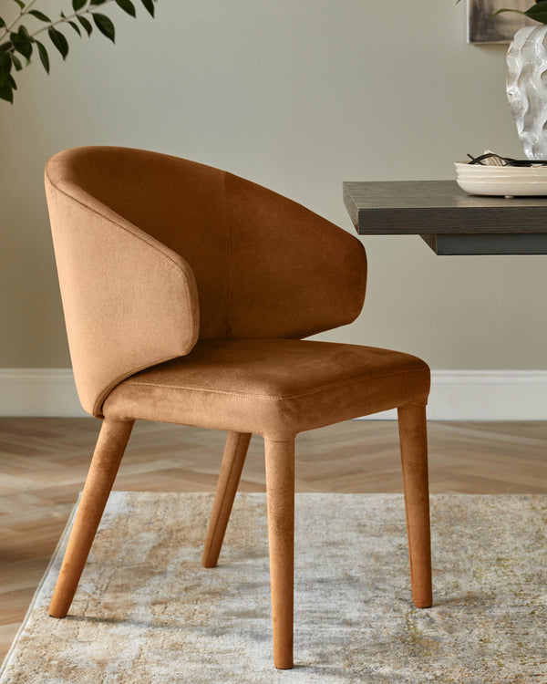 A stylish brown chair with curved armrests sits beside a dark wood table, atop a patterned rug in a modern interior.