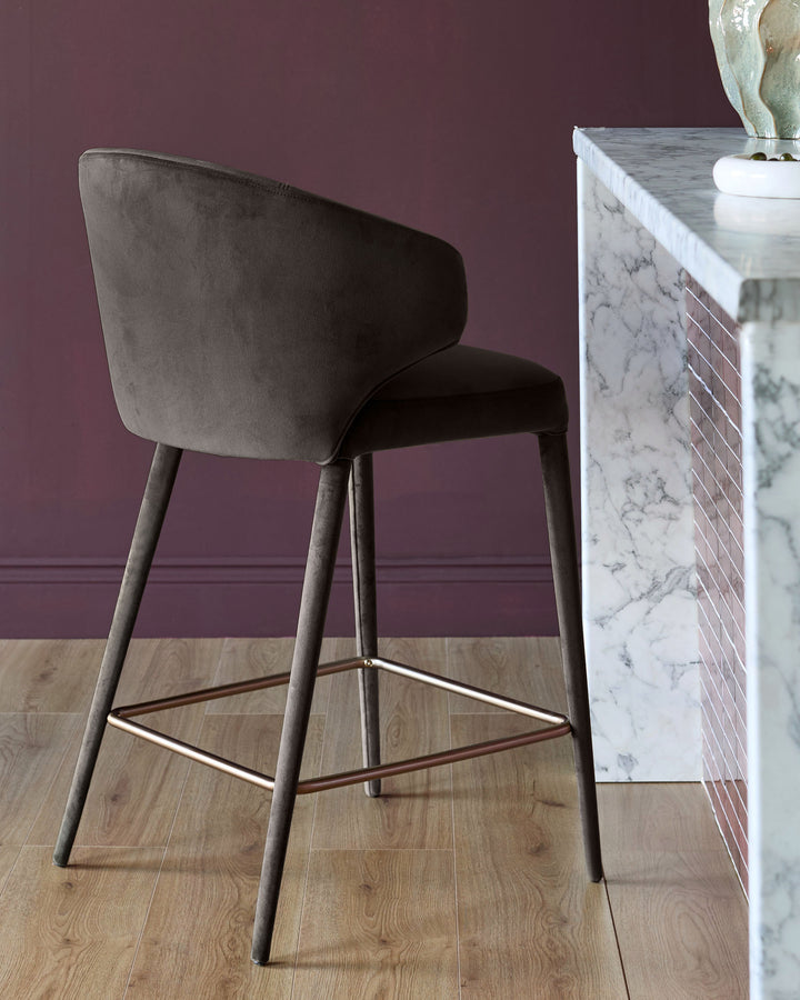 Ethan bar stool in dark chocolate velvet with tapered wooden legs and footrest, rear angle view.