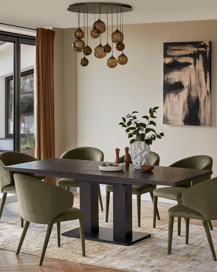 Dining room furniture set featuring a dark wood table, olive green chairs, and statement lighting.