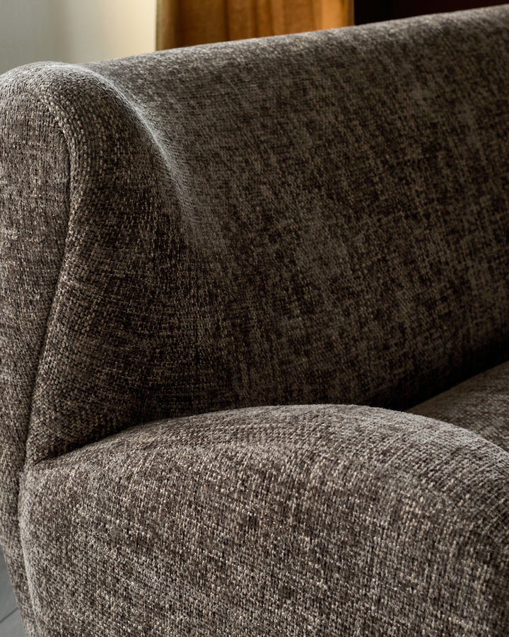 Evelyn 2-seater sofa in mocha fabric, close-up showing textured weave and rolled armrest detail.