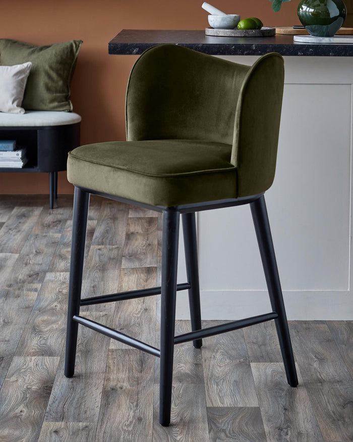 Olive velvet bar stool with a black frame. Modern design adds a touch of elegance.