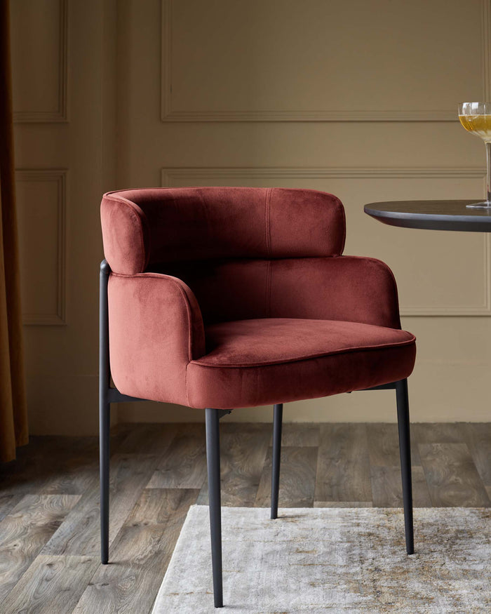 A stylish, modern chair with a plush, reddish-brown fabric seat and sleek, dark metal legs. Minimalist design for sophisticated homes.