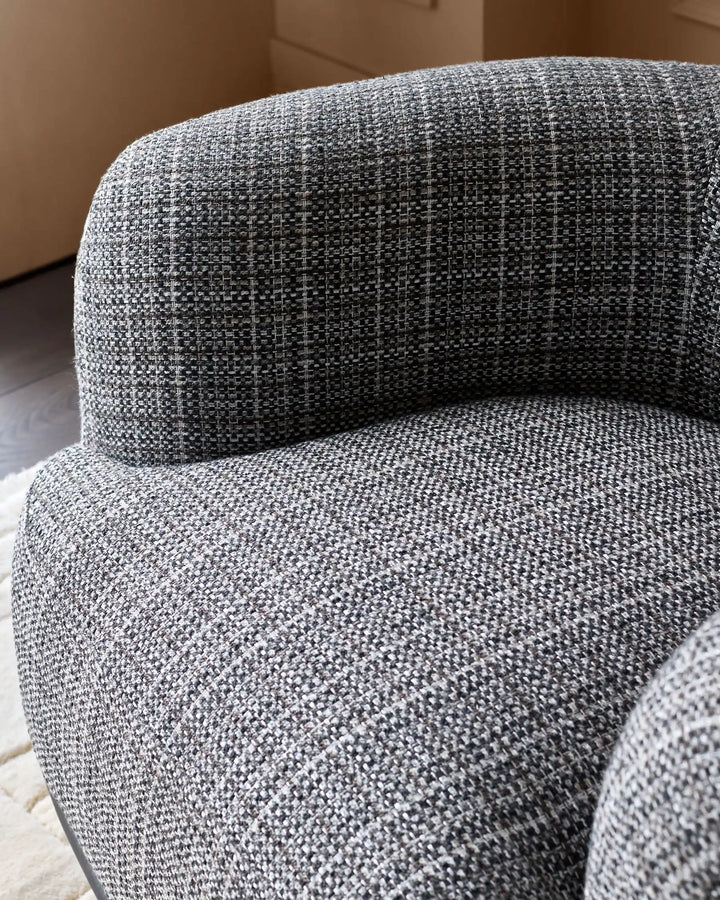 Florence armchair in dark chocolate weave fabric, showing curved back and seat detail from side angle.