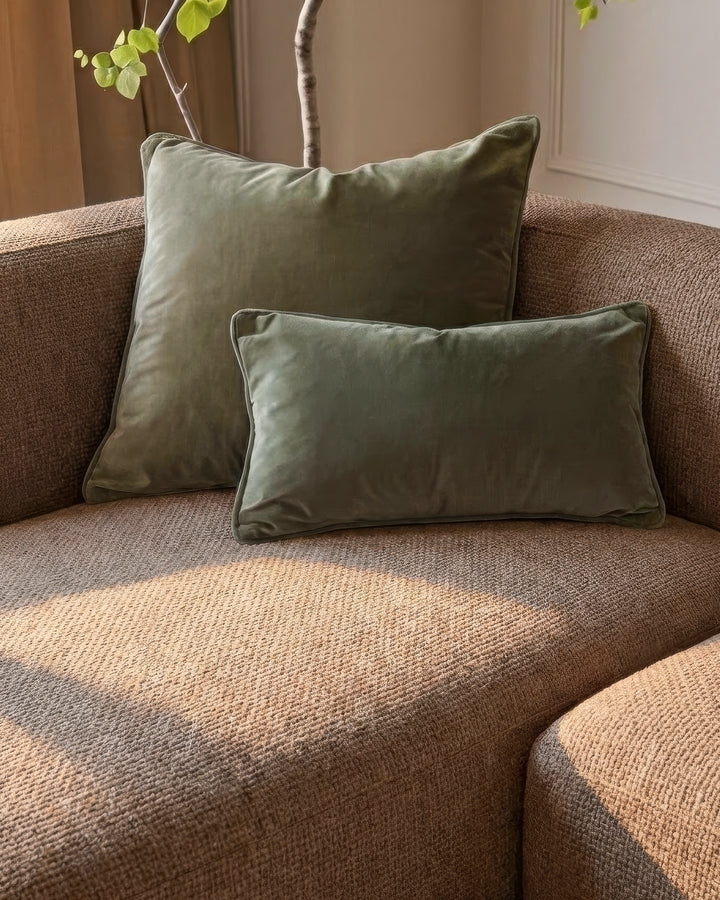 Florence left-hand chaise sofa in mocha fabric with sage green velvet pillows and decorative branch styling.