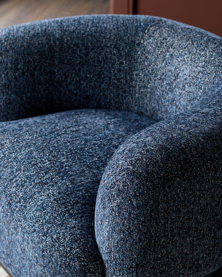 Florence armchair in navy weave fabric, close-up detail showing textured upholstery and curved armrest design.