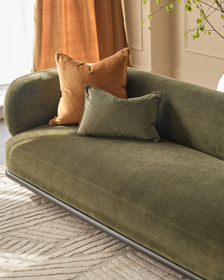 Florence 3-seater sofa in olive green fabric with rounded arms, paired with tan and sage green cushions in a bright room.