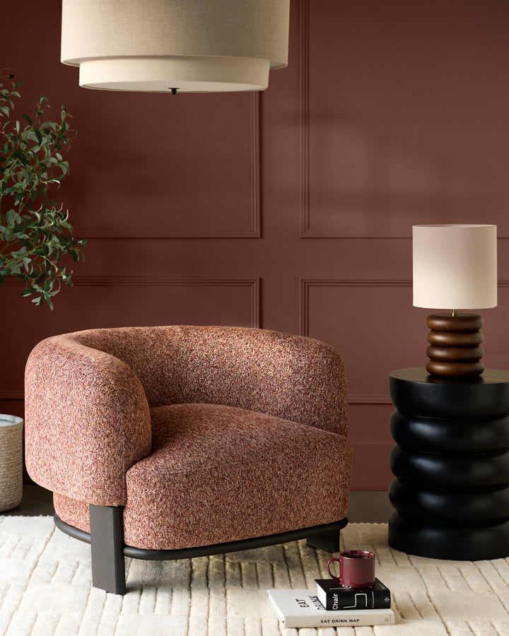 Florence armchair in toffee-red weave fabric with dark wood base, displayed in a styled living room setting.