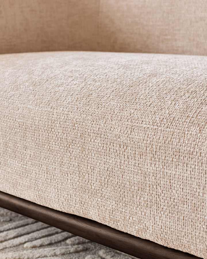 Close-up of Florence 2-seater sofa showing natural fabric texture with dark wood frame detail.