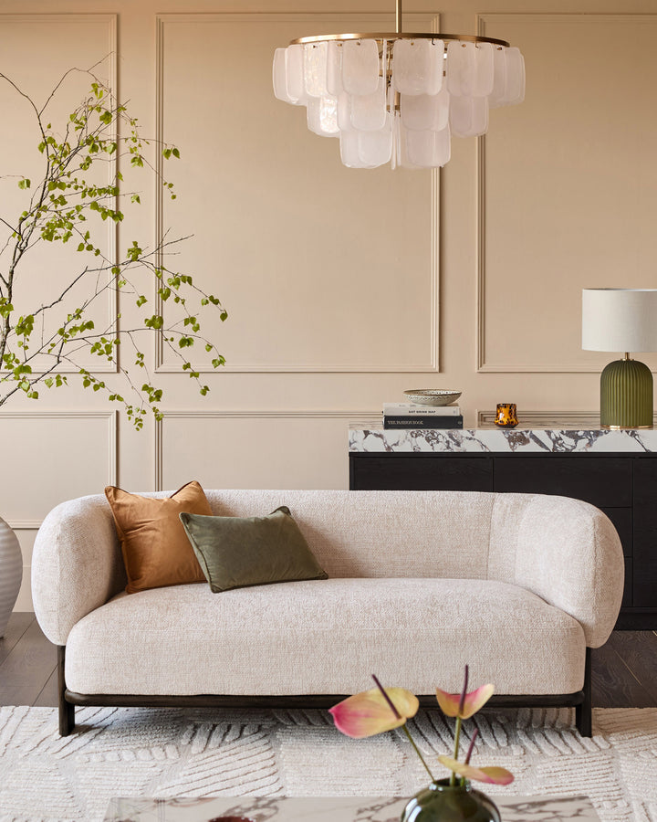 Florence 2-seater sofa in natural fabric with dark wood frame, curved design, styled in modern living room.