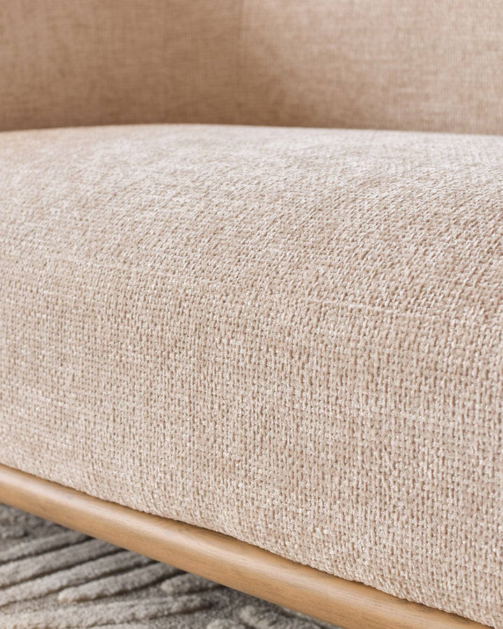 Natural fabric upholstery and wooden frame detail of the Florence 2-seater sofa in natural tones.