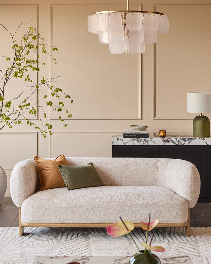 Florence 2-seater sofa in natural linen fabric with natural wood frame, curved design, styled in living room setting.
