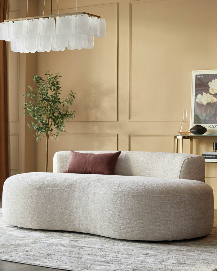 Stylish beige sofa with a brown cushion in a modern living room setting. Minimalist design with neutral tones.