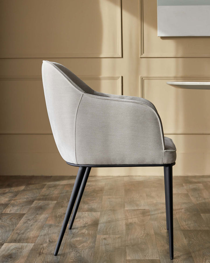 Grey upholstered chair with black metal legs. Stylish and modern dining or accent chair.