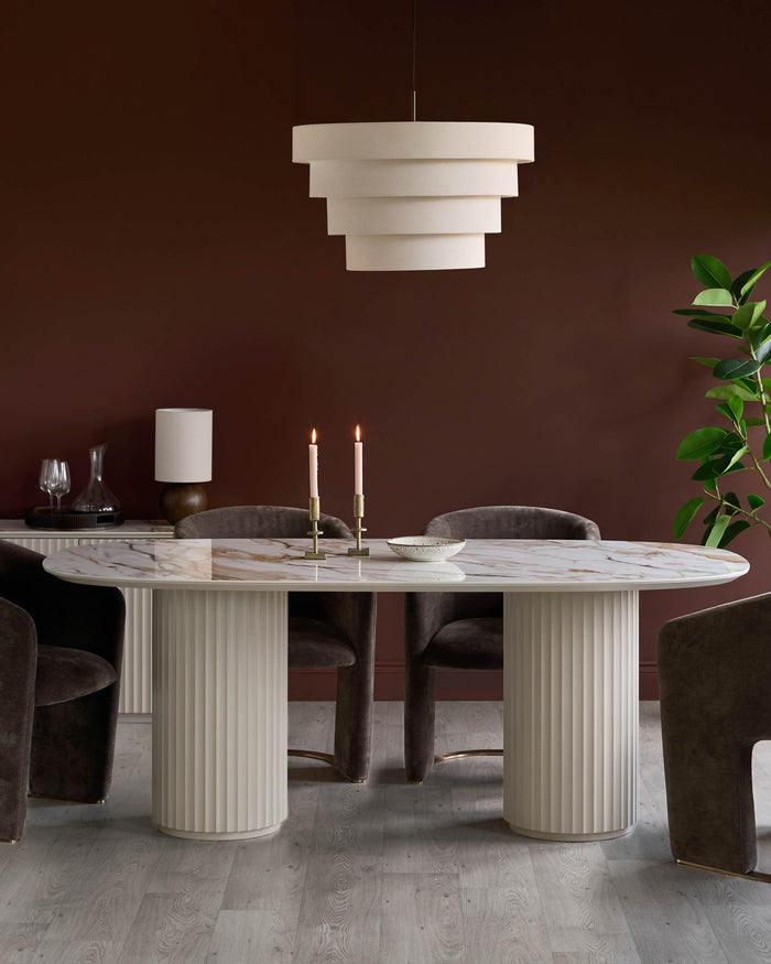 A stylish dining set with a marble-topped table, elegant chairs, and a modern layered pendant light.
