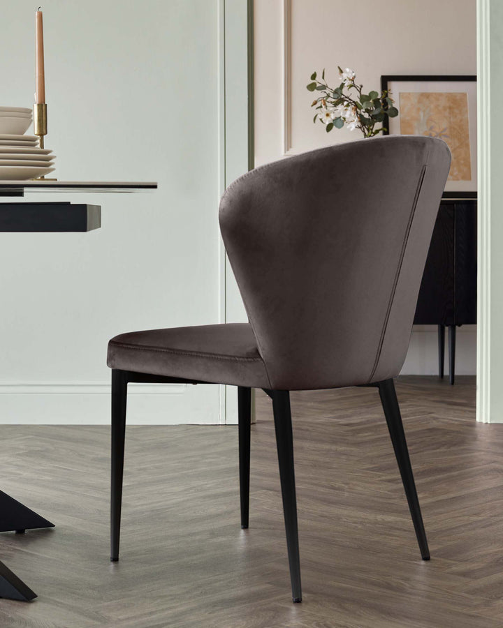 Harper dining chair in mocha velvet with black metal legs, shown from a side angle in a modern dining room setting.