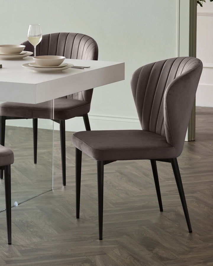 Harper dining chair in mocha velvet with black metal legs, shown in dining room setting at table.