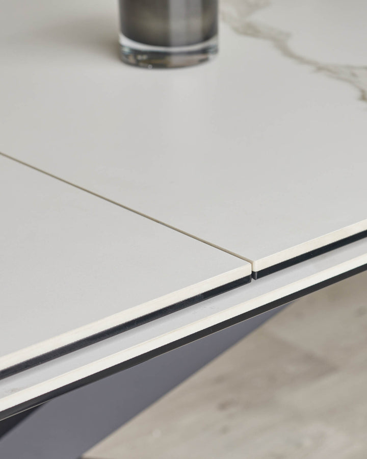 Close-up of a white and grey extendable dining table with a sleek, modern design, perfect for a contemporary dining space.